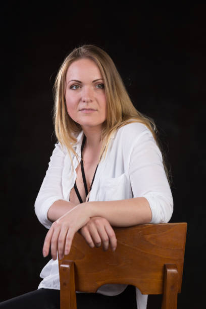istock Blond woman on a dark background 696453830