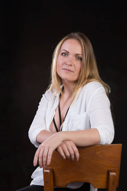 istock Blond woman on a dark background 696453860