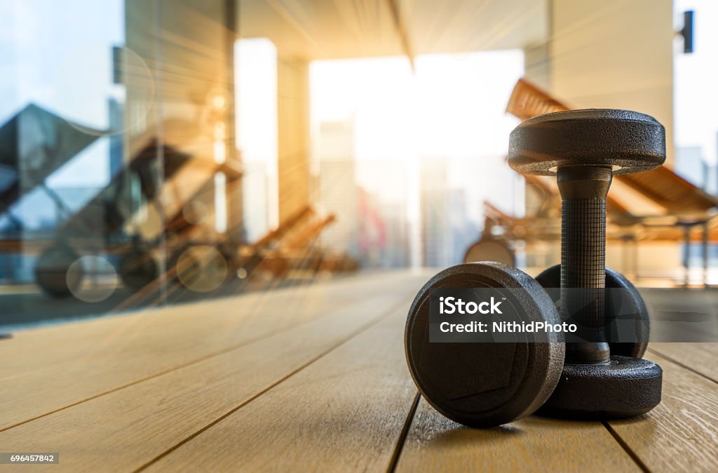 Dumbbell in Fitness Room at the morning dumbells on the floor in fitness room  in the morning : Concept for Healthy Gym Stock Photo