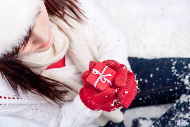 istock Female teenager holding red present 696464166