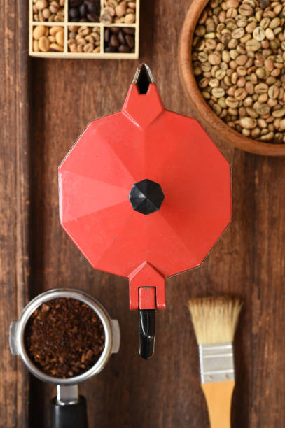 istock Freshly ground coffee beans in a metal filter and coffee beans with red kettle 696471454