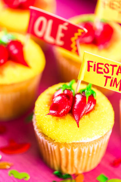 istock Cupcakes decorated with red chili peppers 696471506