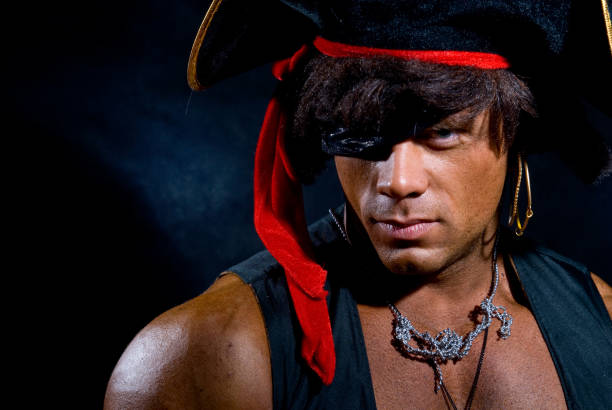 istock Close-up portrait muscular pirate in the studio on a dark background. 696472102