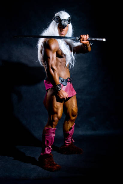 istock Muscular man warrior with a sword on his shoulder 696472138