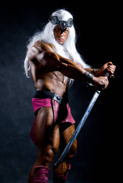 istock Muscular man warrior with white long hair holding a sword 696472146