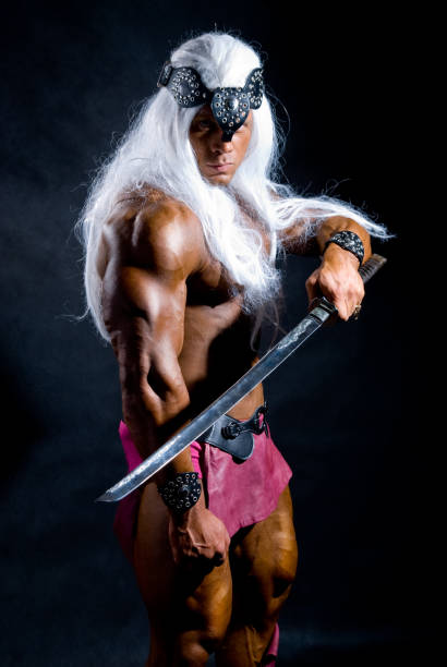 istock Muscular man warrior with white long hair holding a sword 696472148
