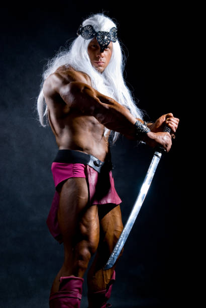 istock Naked muscular man warrior with a sword. 696472152
