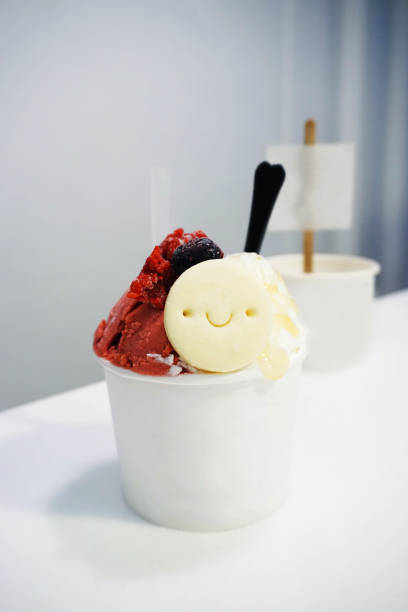 Raspberry sorbet and Plain yogurt - A takeaway cup of Ice cream with cookie and honey.