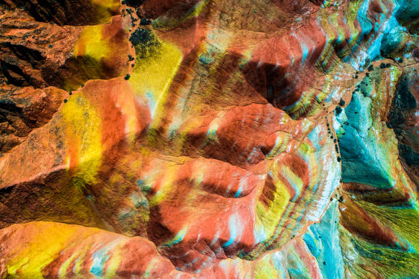 Aerial top down view on Zhangye Rainbow mountains displaying colorful pattern Colorful Rainbow Mountains in Zhangye National Geopark; aerial top down view on sandstone hills and mountain chains covered with amazing pattern due to deposition of minerals, Gangsu, China, May 2017 zhangye danxia geopark china stock pictures, royalty-free photos & images
