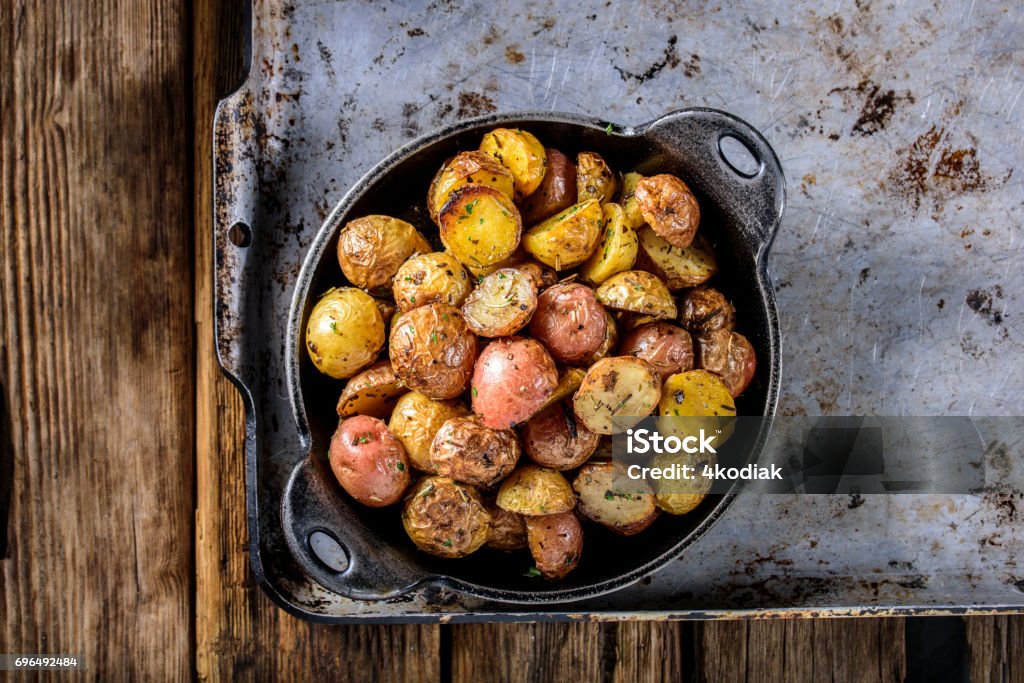 Pan Fried Yukon Gold Potatoes with Herb in Cast iron Delicious gold potatoes and herb Cooking Pan Stock Photo