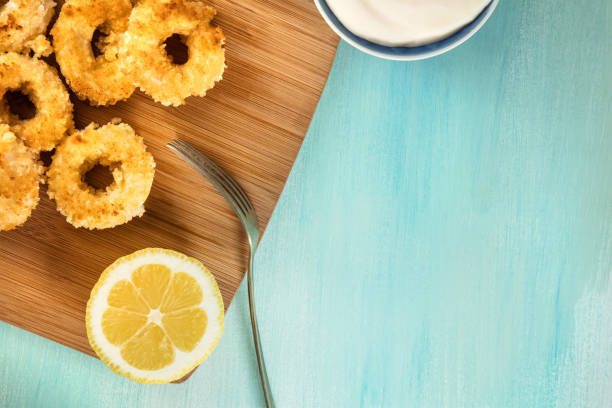 istock Calamari rings, mayonnaise sauce, lemon, copy space 696496596