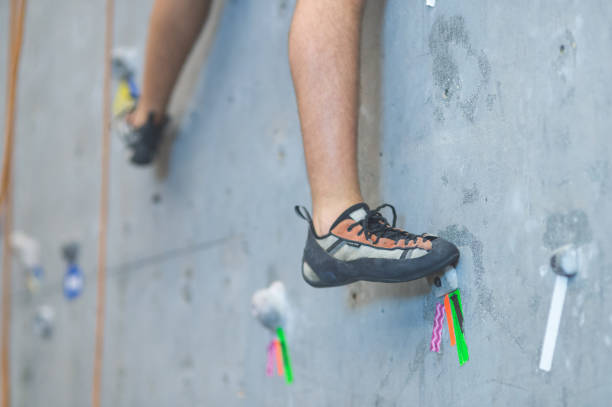 istock Young man climbing indoor rock wall 696499472