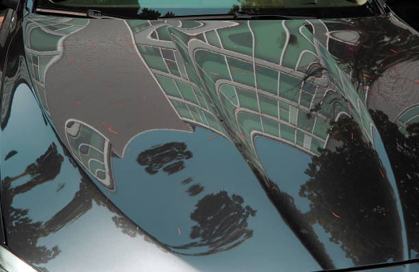 istock Modern building reflections on cars hoods 696500130