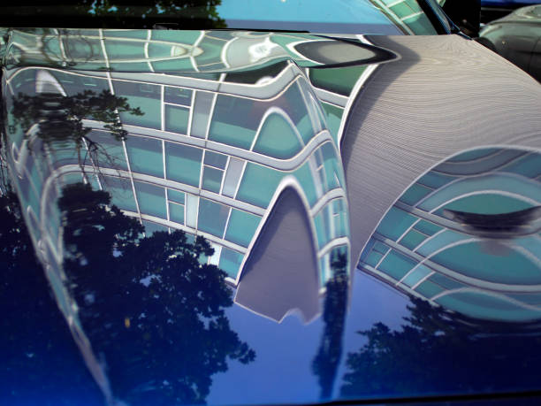 istock Modern building reflections on cars hoods 696500314