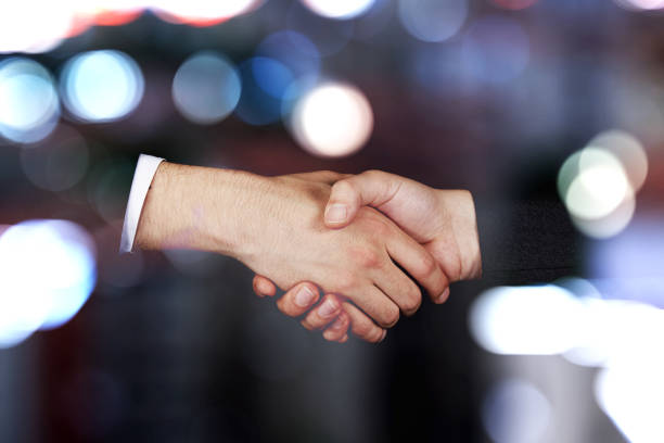 Businessmen shaking hands at the blurred background