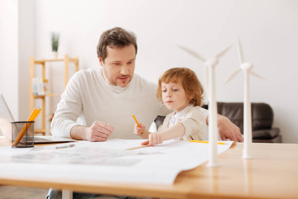 istock Competent engineer looking at the process of his son 696517658