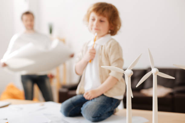 istock Focused photo on models of windmills that standing on the foreground 696518126