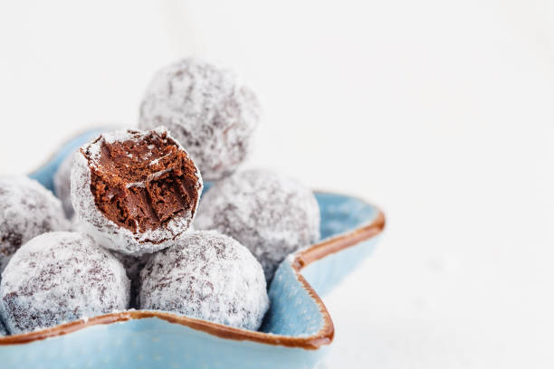 istock Bitten chocolate truffle in sugar powder 696518556