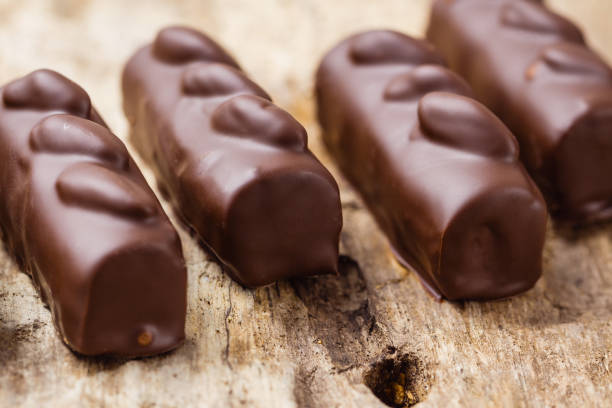 istock Luxury handmade chocolate  bonbons on wooden background 696518566