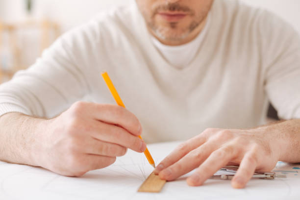 istock Close up of serious man that working at interesting sketch 696518808