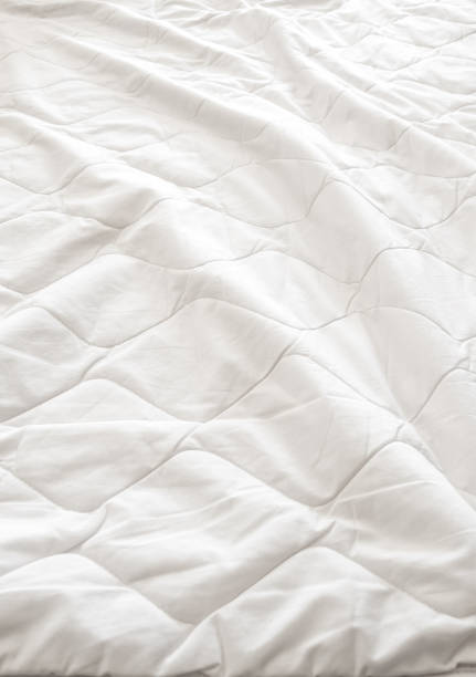 istock White blanket crumpled on the bed 696519018