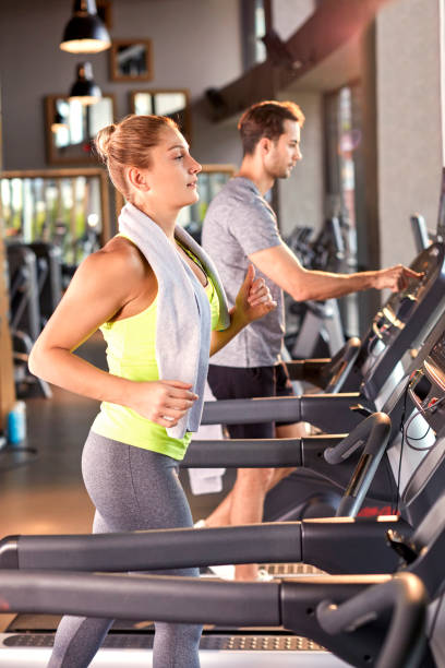 istock Healthy Woman Running on Treadmill 696521832