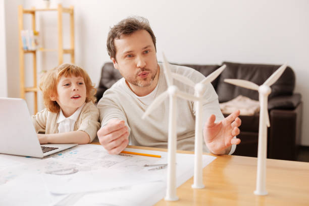 istock Joyful male person blowing on windmills 696521854