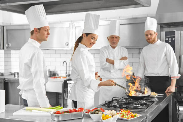 istock Chefs are cooking flaming pan in the kitchen 696522106