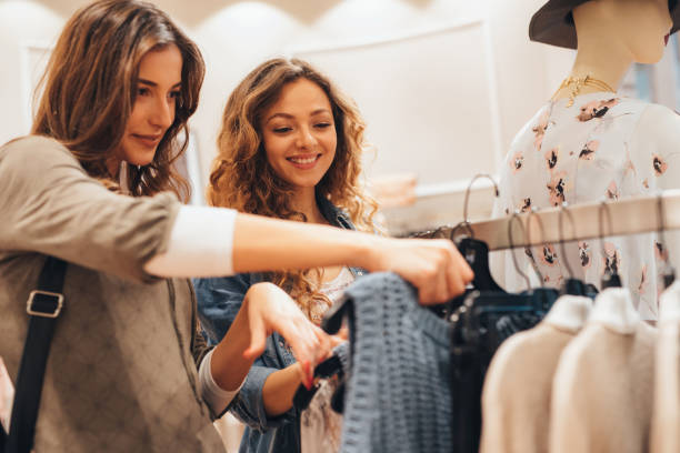 istock Two friends shopping for clothes 696526280