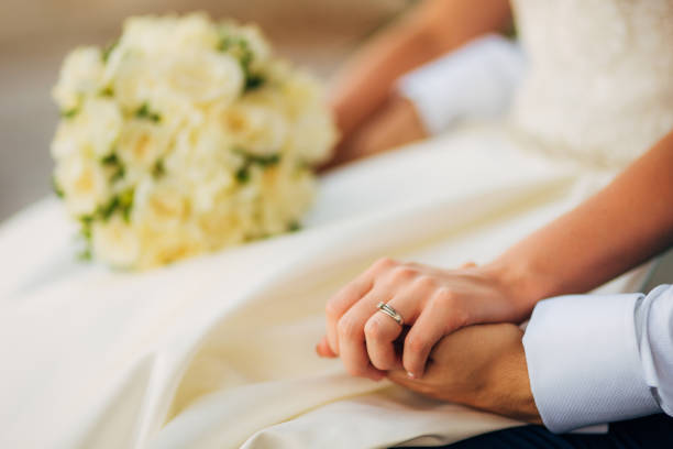 istock Bride and groom holding hands 696529452