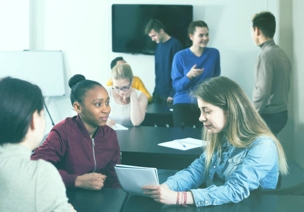 istock Emotional and female students having conversation at recess 696532116