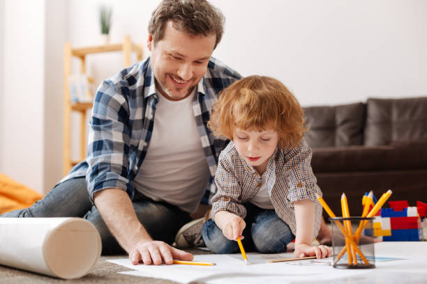 istock Positive delighted male person spending time with his son 696532422