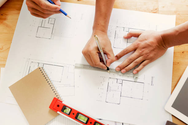 istock Team of engineers working together in a architect office. 696532650