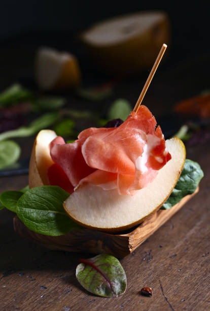 istock prosciutto with pear on a wooden table 696536254