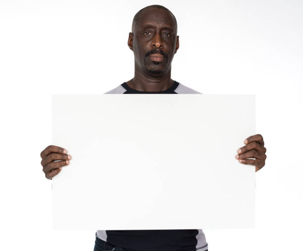 istock African descent man is holding a placard 696539636