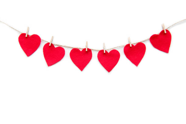istock Red heart paper cut decorations hanging on clothespins isolated on white 696540504
