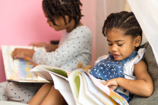 istock Two African American sisters play happily together 696542878