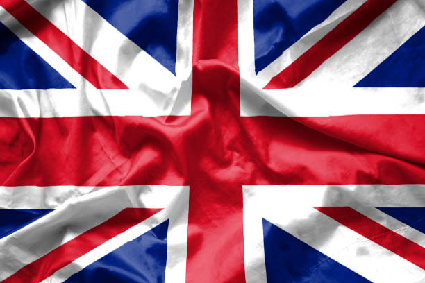 istock British UK flag background waving with fabric texture, Union Jack. 696543994