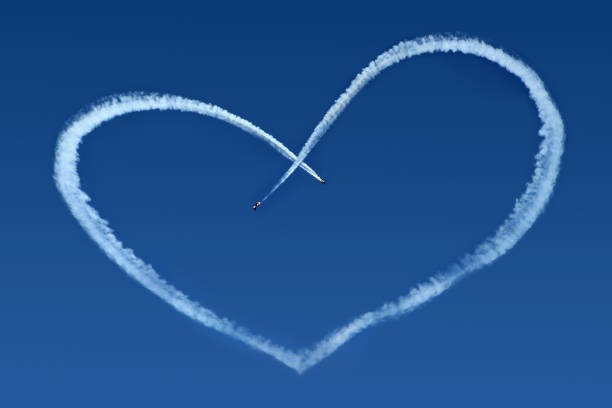 istock Airplanes Skywriting a Heart on blue sky 696545522