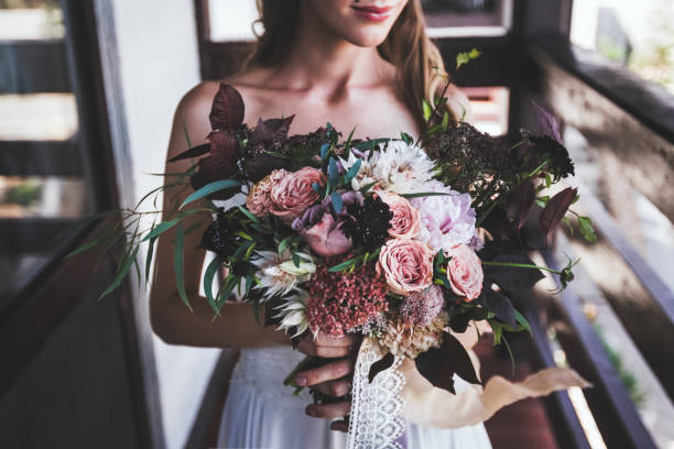 istock luxurious bouquet in bride's hands. Rustic style in dark tones 696546568