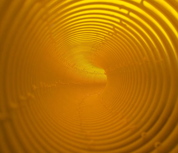 istock Inside the striped orange tunnel pipe, abstract background. 696549666