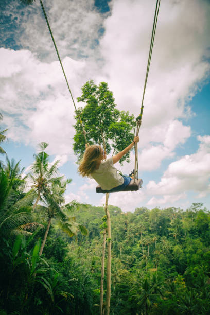 istock Young attractive girl swinging in nature. 696556576