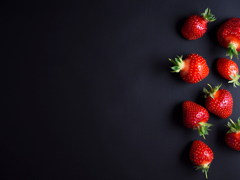 Fresh red, ripe strawberries isolated on black background