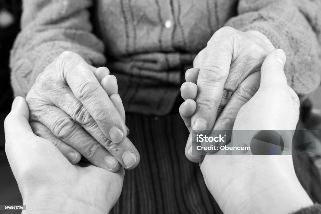 The helping hands Young carer giving helping hands for elderly woman Dementia Stock Photo