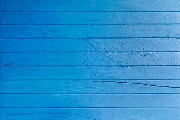 istock Weathrered and worn blue wooden board background. 696573756
