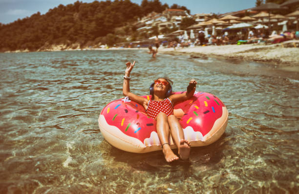istock Little girl in life preserver enjoying the music 696584708