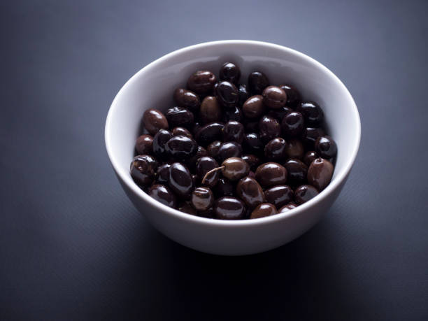 istock French olives isolated on black 696585604