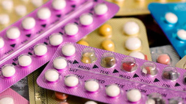 Oral contraceptive pill on pharmacy counter. Oral contraceptive pill on pharmacy counter with colorful pills strips background. estrogen photos stock pictures, royalty-free photos & images