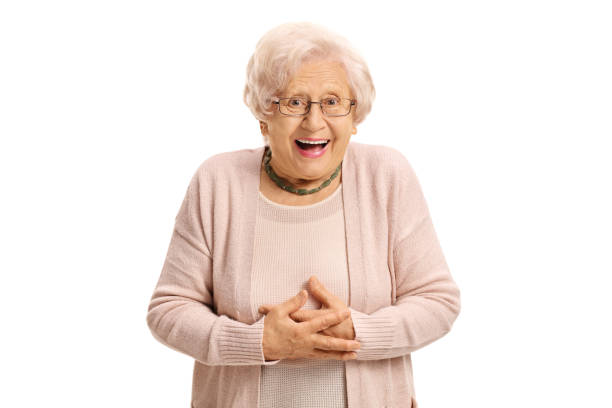 donna anziana sorpresa che guarda la telecamera e ride - isolated on white surprise happiness joy foto e immagini stock