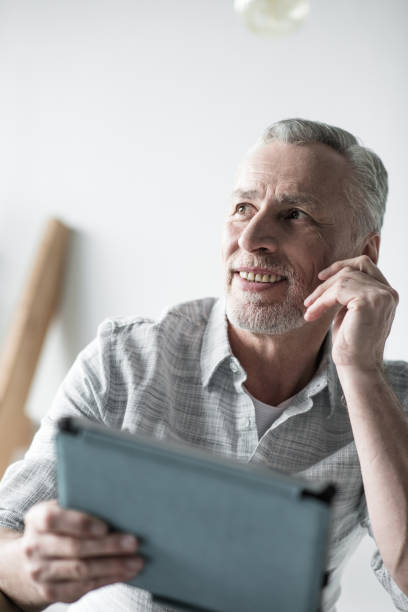 istock senior businessman working with tablet computer in office 696590224